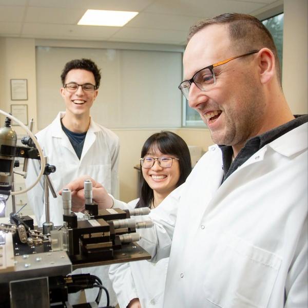 Dr. Duncan in foreground with smiling students in background