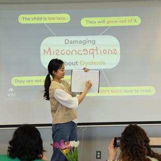 Student giving a presentation on misconceptions about dyslexia at CREATE.