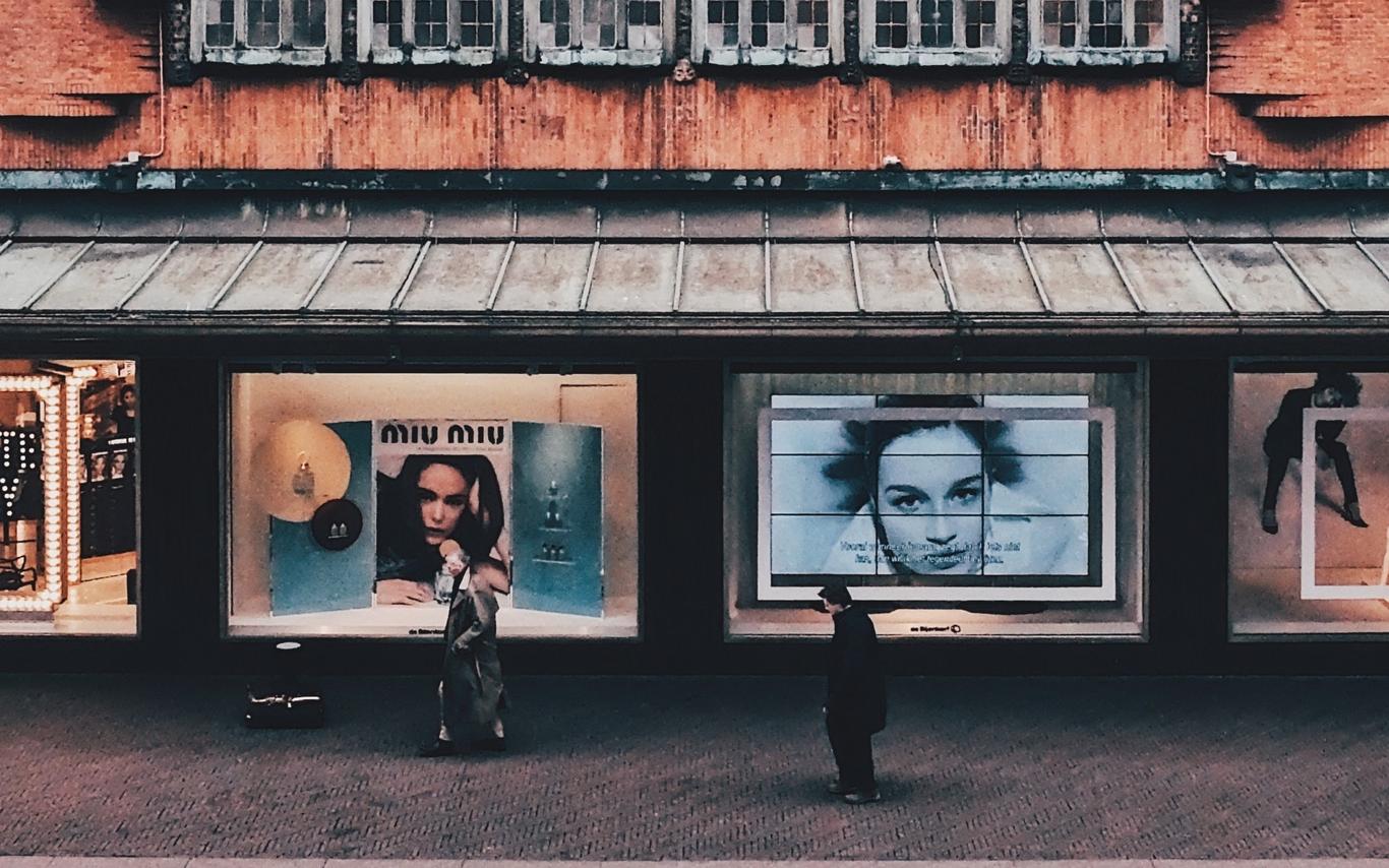 Posters on building with people in front