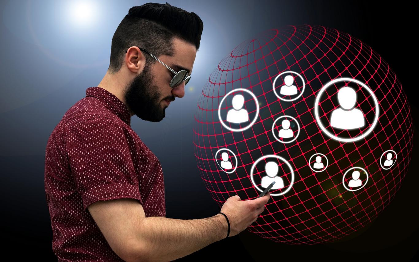 Man in sunglasses looking at phone